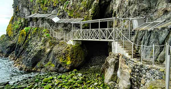 Cliffside bridge over a pebble beach